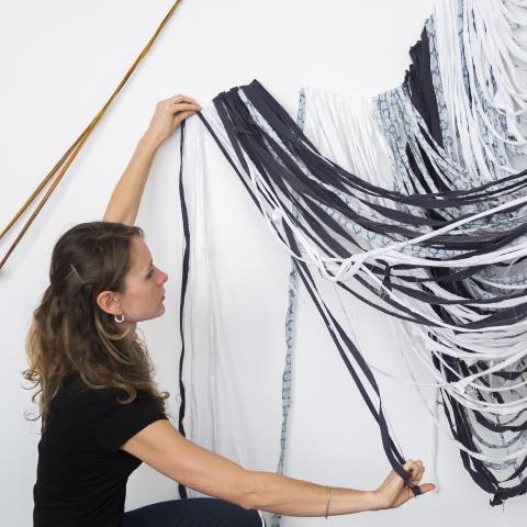woman draping fabric artistically
